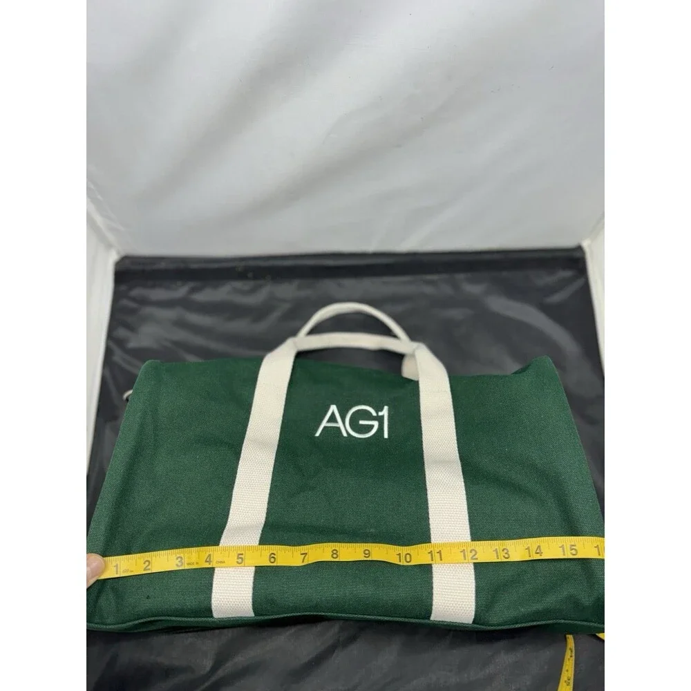 AG1 Duffle Bag Unisex Green Canvas White Handles Accents Adjustable Strap NWOT
